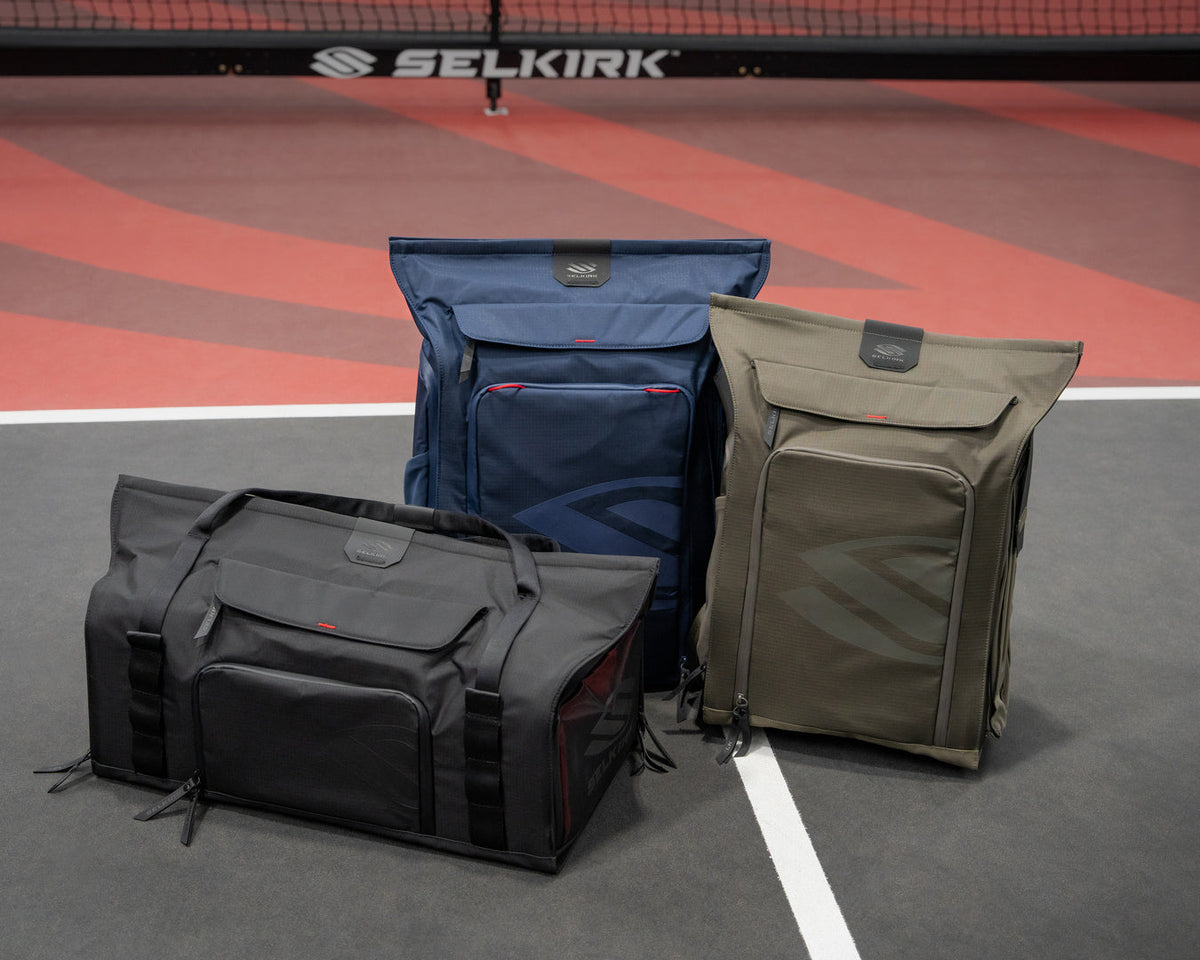 Three pickleball bags on a pickleball court