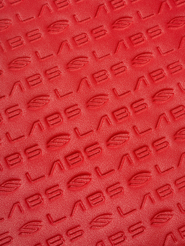 Red textured material embossed with repeating 'LABS' and leaf logo pattern.