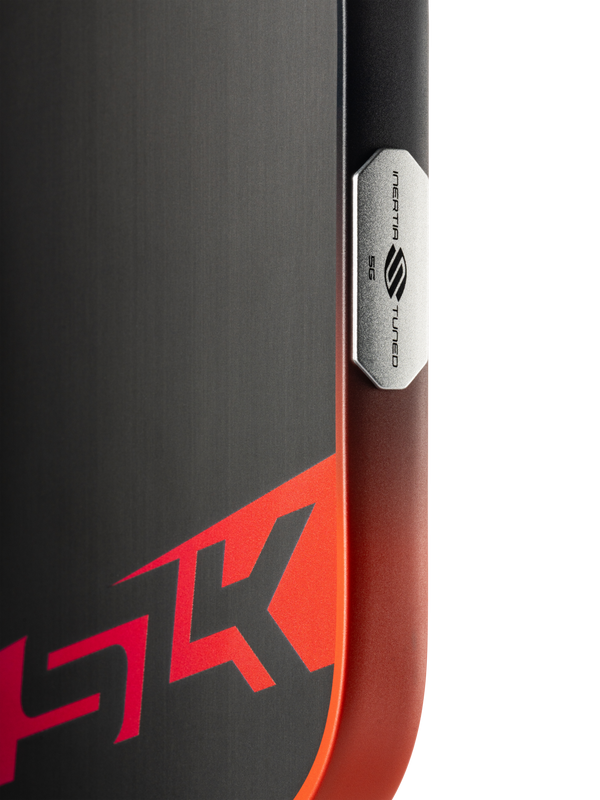 Brushed-metal device corner with red HK logo and vertical badge reading INERTIA 5G TUNED